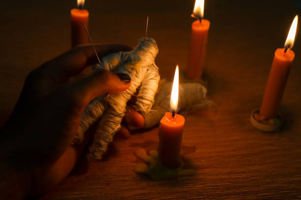 Candle light in the dark and curse doll, candle light ceremony
